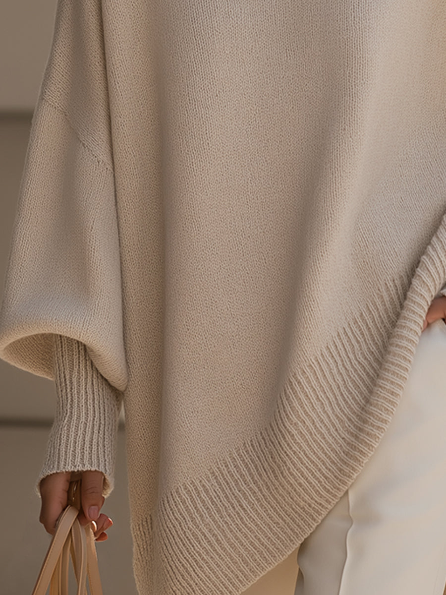 Detailansicht des gerippten Saums und der gerippten Ärmelbündchen am beigen Strickponcho 4