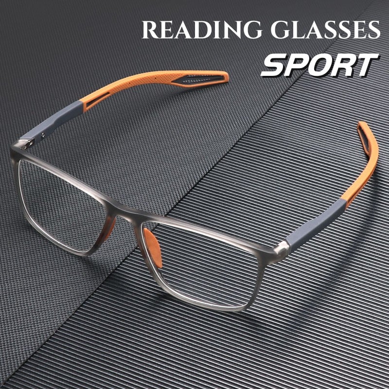 Sportliche Lesebrille mit grauem, durchscheinendem Rahmen und orangefarbenen Bügelenden auf dunkler, gerillter Unterlage
