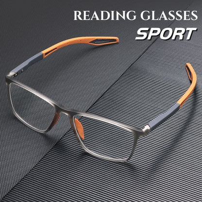 Sportliche Lesebrille mit grauem, durchscheinendem Rahmen und orangefarbenen Bügelenden auf dunkler, gerillter Unterlage