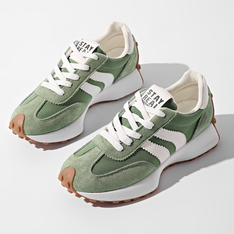 Paar grüne Wildleder-Sneaker mit weißen Streifen und Plateausohle, von oben auf hellem Hintergrund fotografiert 1