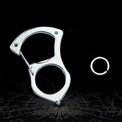 Silberner Edelstahl-Karabiner ohne Griffauflage mit separatem Schlüsselring vor dunklem Hintergrund, darunter ein Muster aus Rissen wie in zersprungenem Glas. 4