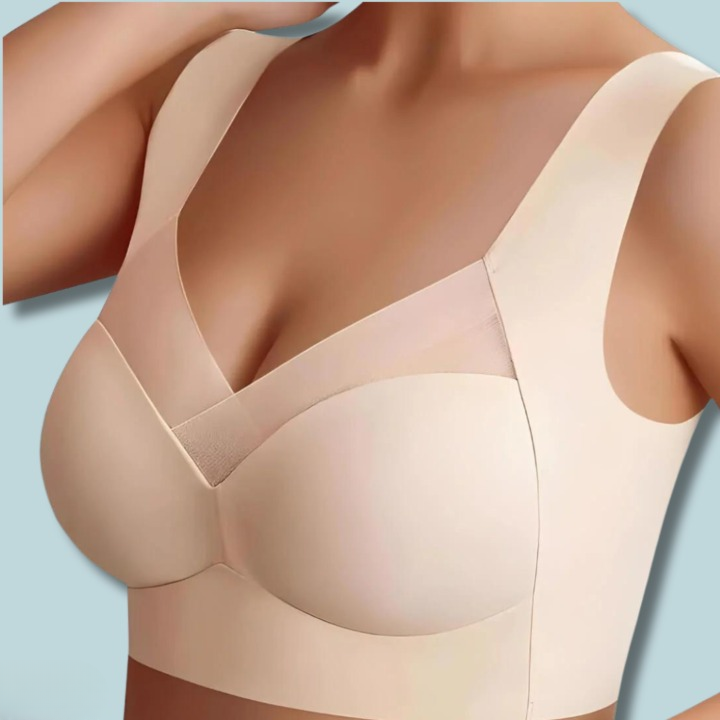 Vorderansicht des beigen BHs am Model mit glatten, nahtlosen Cups, breiten Trägern und Netzeinsatz im Ausschnitt. 4