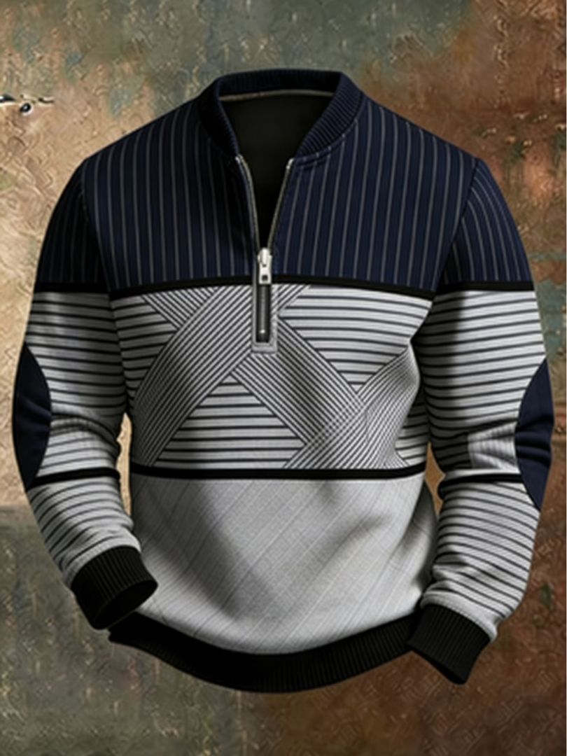 Frontansicht des Pullovers in Marineblau und Hellgrau mit geometrischem Muster, kurzem Reißverschluss und gerippten Bündchen.