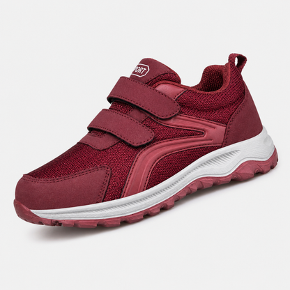Einzelner roter Schuh mit zwei Klettriemen und weißer Sohle, seitlich von vorne fotografiert 7