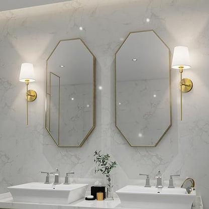 Zwei achteckige Spiegel mit goldenen Rahmen, Wandlampen, Doppelwaschbecken, modernes Badezimmerdesign.