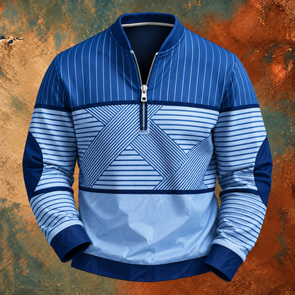 Die Variante in kräftigem Blau und hellem Himmelblau, frontal dargestellt, mit Streifenmuster, kurzem Reißverschluss und abgesetzten Ellbogenpartien. 4