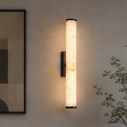 Leuchtende Marmorröhre mit schwarzer Halterung an der Wand neben einem abstrakten Bild