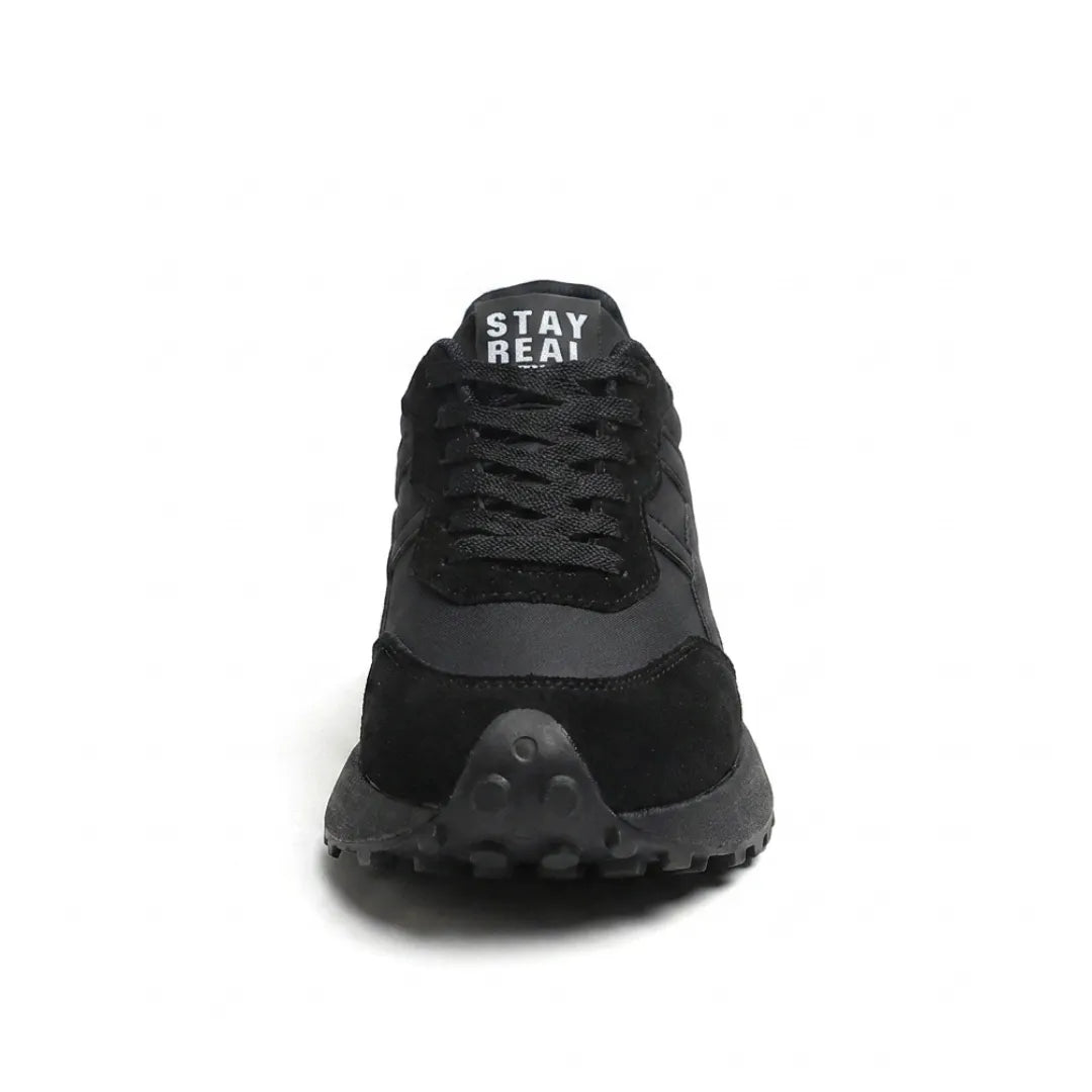 Schwarzer Sneaker von vorne mit Schnürung, Veloursleder-Kappe und genoppter Sohlenspitze 9