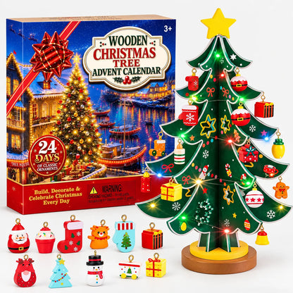 Grüner Holzbaum mit gelbem Stern, Lichterkette und bunten Anhängern vor der Verpackung, davor elf einzelne Figuren 2