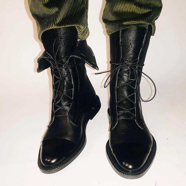 Schwarze Lederstiefel mit Schnürung, glänzende Kappe, Herrenmode, elegantes Design, Herbstmode.