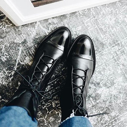 Schwarze Lederstiefel mit Schnürung, glänzende Kappe, Damenmode, Herbst-Winter-Trend.