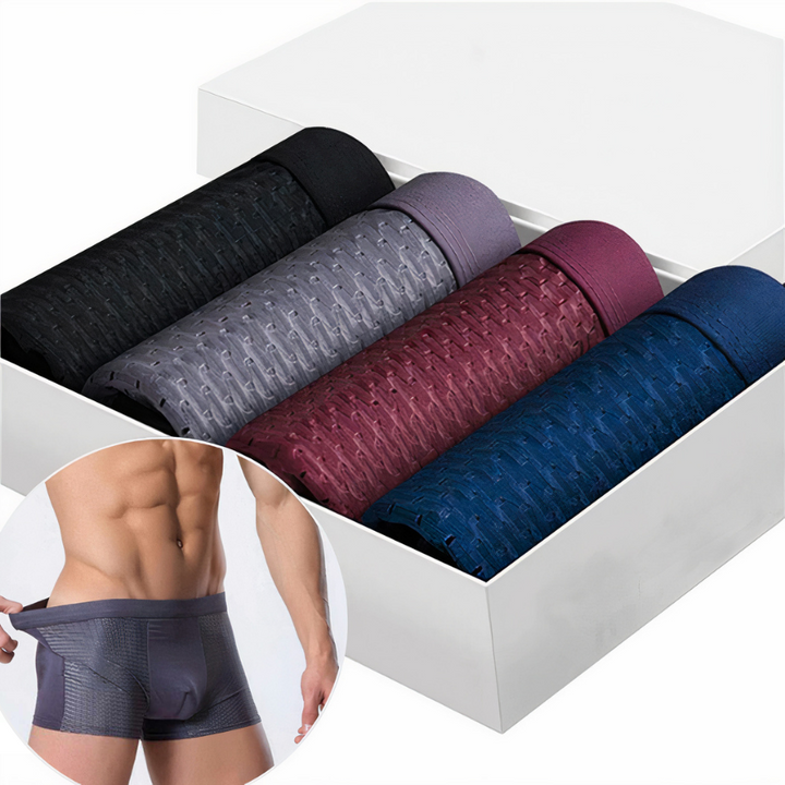 Vier gerollte Boxershorts in Schwarz, Grau, Weinrot und Blau in weißer Box, Model im Ausschnitt 1