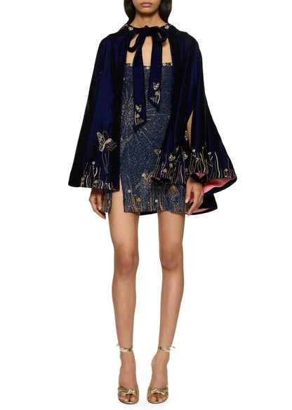 Model trägt das Kleid kombiniert mit einem dunkelblauen Samtcape mit Schleife und passender Goldstickerei 9