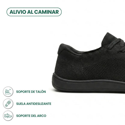 Schwarzer Sneaker, Fersenbereich im Anschnitt, daneben Symbole zu Fersenhalt, rutschfester Sohle und Fußgewölbeunterstützung. 13