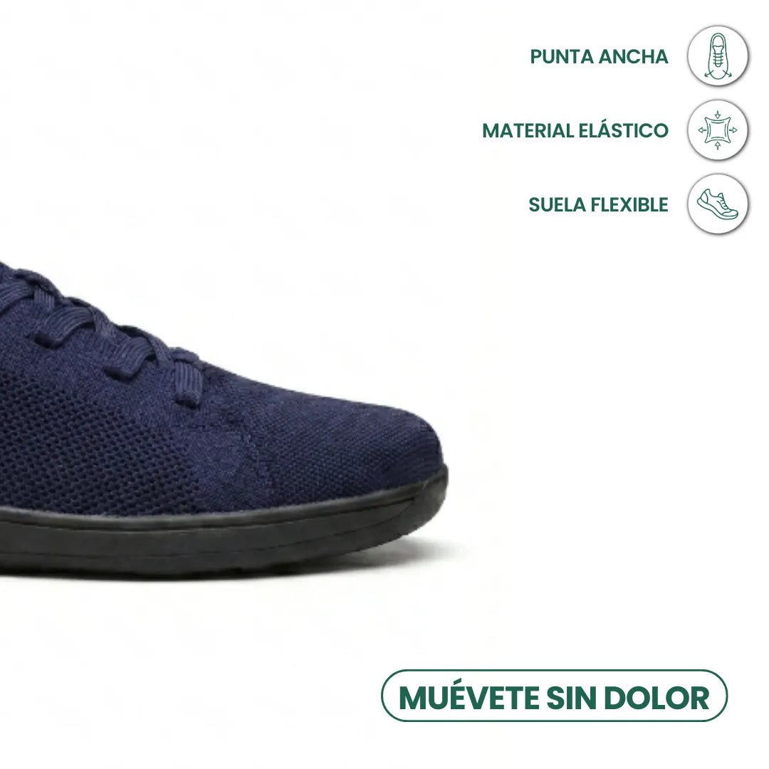 Nahaufnahme der Spitze des marineblauen Mesh-Sneakers mit schwarzer Sohle, daneben Symbole für weite Zehenbox, elastisches Material und flexible Sohle 23