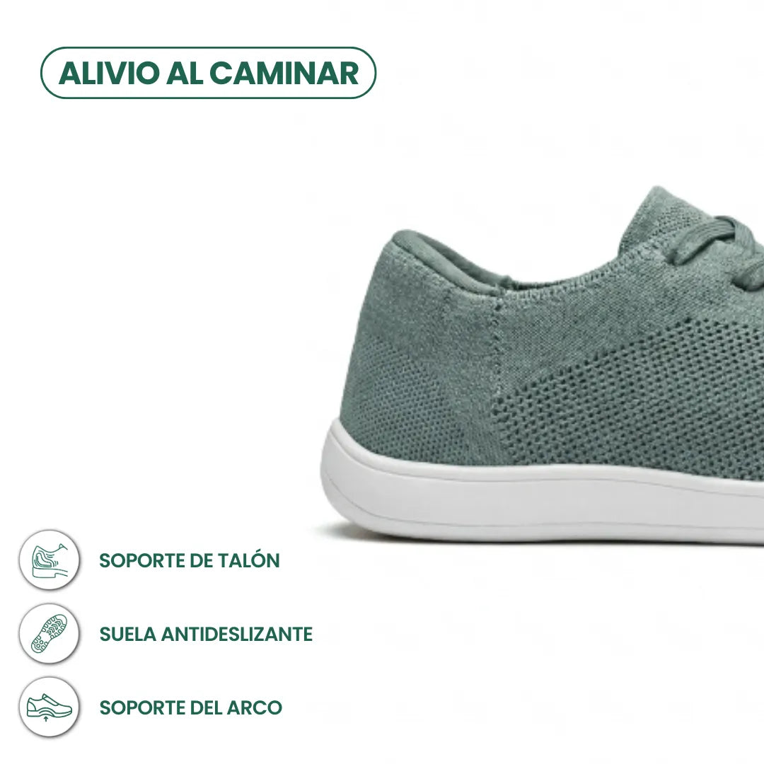 Seitliche Detailansicht der Ferse des graugrünen Mesh-Sneakers mit weißer Sohle und Symbolen für Fersenhalt, rutschfeste Sohle und Fußgewölbestütze 31