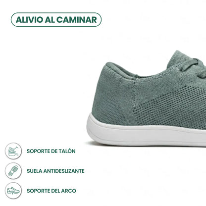 Seitliche Detailansicht der Ferse des graugrünen Mesh-Sneakers mit weißer Sohle und Symbolen für Fersenhalt, rutschfeste Sohle und Fußgewölbestütze 31