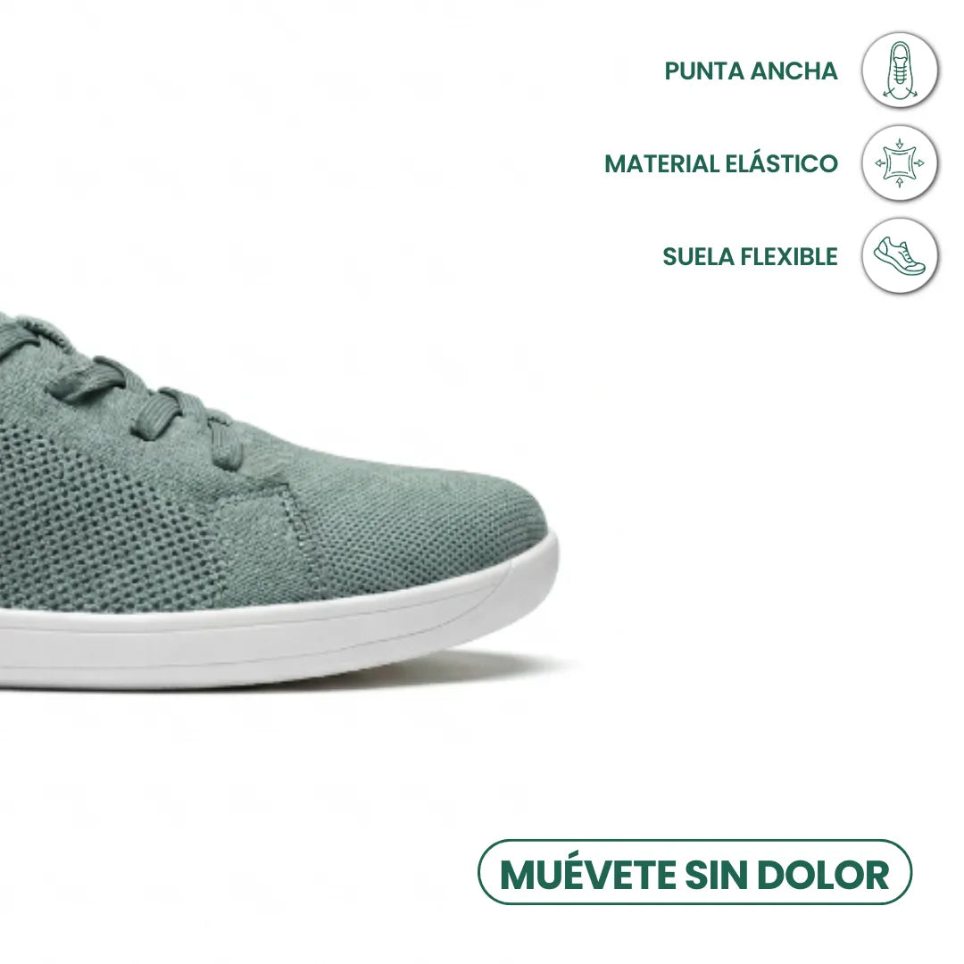 Nahaufnahme der Spitze des graugrünen Mesh-Sneakers mit weißer Sohle, daneben Symbole für weite Zehenbox, elastisches Material und flexible Sohle 32
