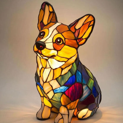 Sitzende Corgi-Figur im Buntglas-Look mit großen Ohren, hellem Gesicht und blau-grün-roten Mosaikflächen am Körper, warm leuchtend. 24