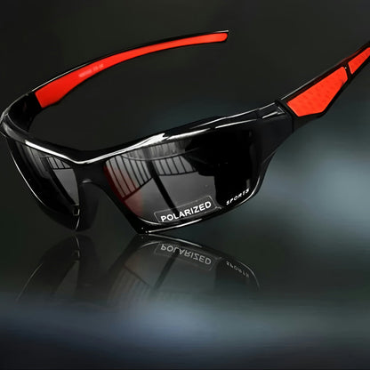 Schwarze Sportbrille mit dunklen Gläsern und roten Bügelakzenten, schräg vor dunklem Hintergrund mit Spiegelung 1