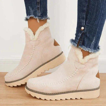 Beige Damen-Stiefeletten aus Leder mit flauschigem Futter und Ziernaht, Seitenansicht.