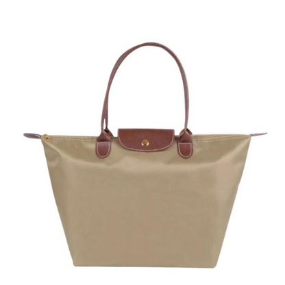 Beige Damenhandtasche aus Leder und Stoff, elegantes Design, braune Henkel.