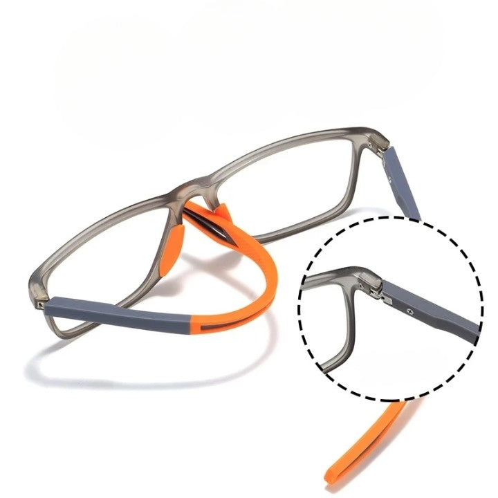 Brille mit grauem Rahmen, die flexiblen orangefarbenen Bügelenden sind abgebogen; Ausschnittvergrößerung zeigt das Scharnier am Bügel. 10