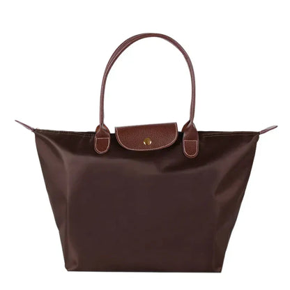 Braune Damenhandtasche aus Leder und Nylon, elegant, geräumig, mit Tragegriffen.