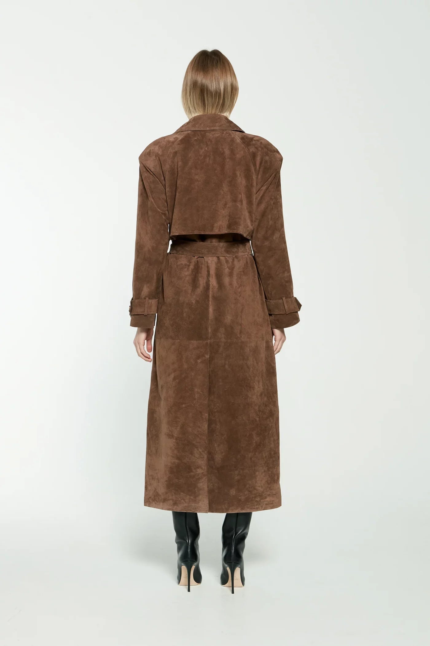 Frau in braunem Wildledermantel, Rückansicht, modisch, Herbstmode, knielange Stiefel.
