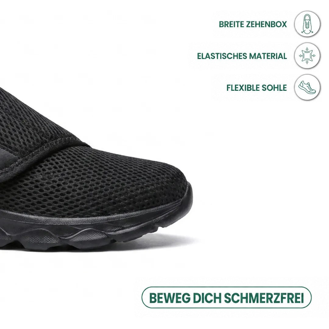 Nahaufnahme der breiten schwarzen Schuhspitze aus Netzgewebe, daneben Symbole für breite Spitze, elastisches Material und flexible Sohle. 14