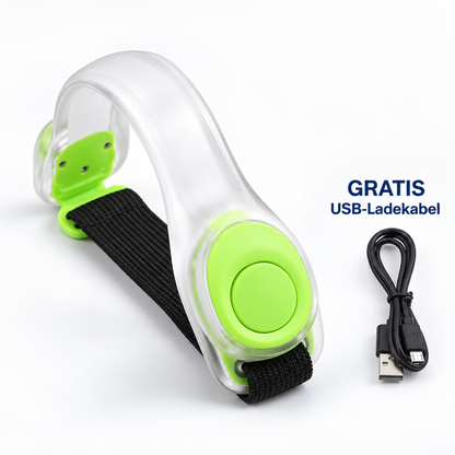 Transparentes Leuchtarmband mit grünen Akzenten und schwarzem Band, daneben ein schwarzes USB-Ladekabel 11