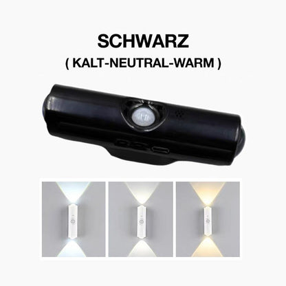 Schwarze Wandleuchte mit Bewegungssensor in der Mitte, darunter drei weiße Lichtfarben an der Wand 3