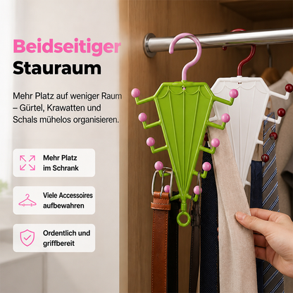 Grüner und weißer schirmförmiger Hänger an der Kleiderstange, behängt mit Gürteln, Krawatten und Schals, eine Hand greift zu 1