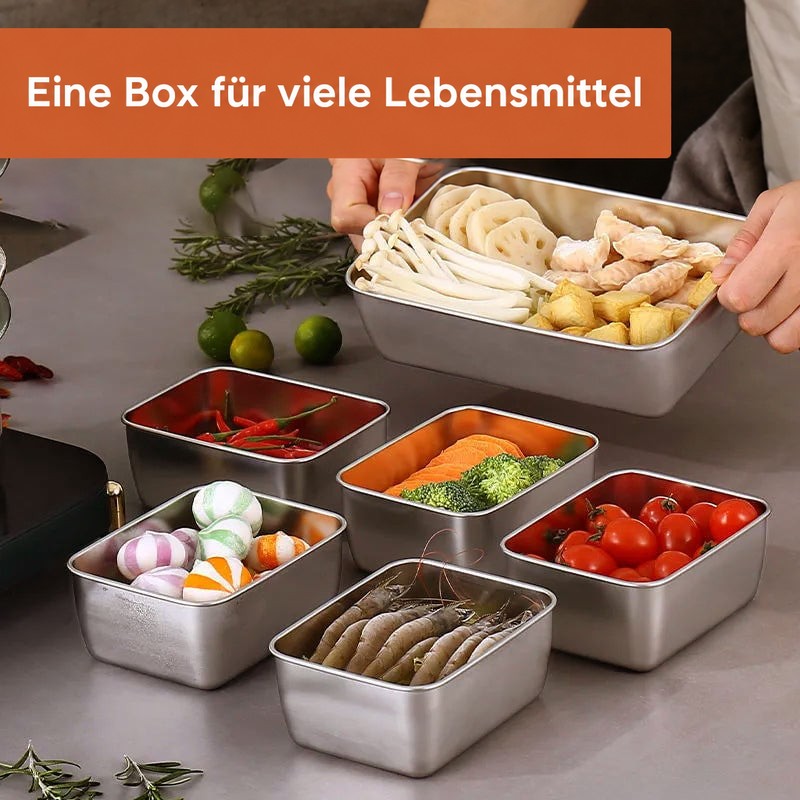 Mehrere Edelstahlbehälter auf der Arbeitsplatte, gefüllt mit Pilzen, Lotuswurzel, Garnelen, Tomaten, Brokkoli, Chilis und Süßigkeiten. 3