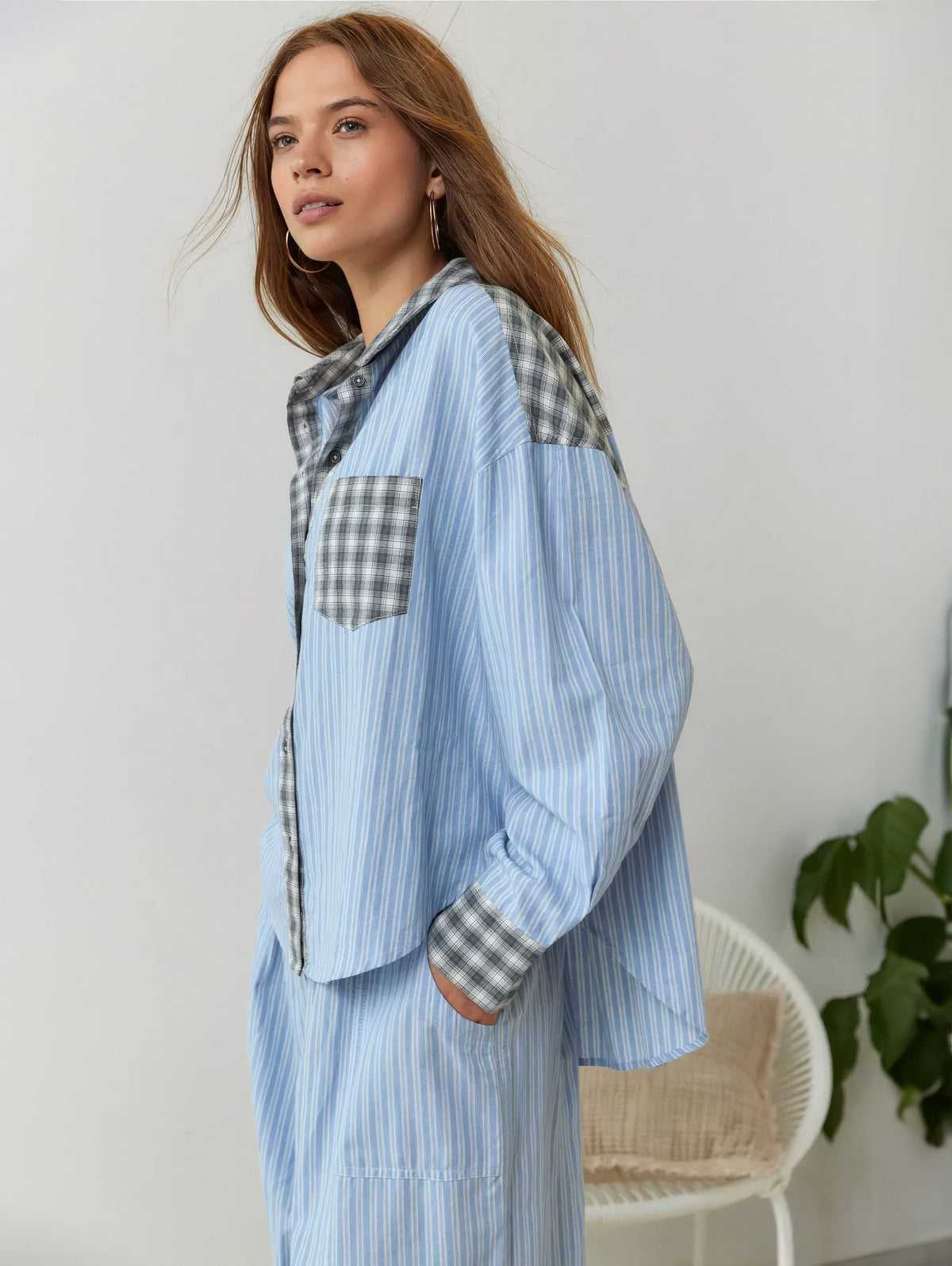 Seitenansicht des blau gestreiften Pyjama-Sets mit grau karierten Einsätzen