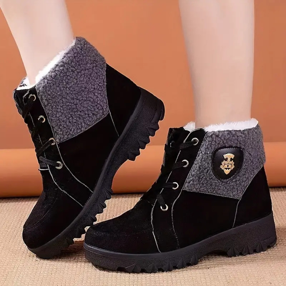 Schwarze Damen-Winterstiefel mit grauem Futter, rutschfeste Sohle, warm gefüttert.