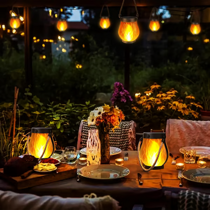 Gedeckter Abendtisch im Garten mit zwei Laternen auf dem Tisch und weiteren darüber hängend 7