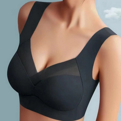 Getragener nahtloser BH in Schwarz mit Netzeinsatz im V-Ausschnitt und breiten Trägern, Nahaufnahme am Model. 3