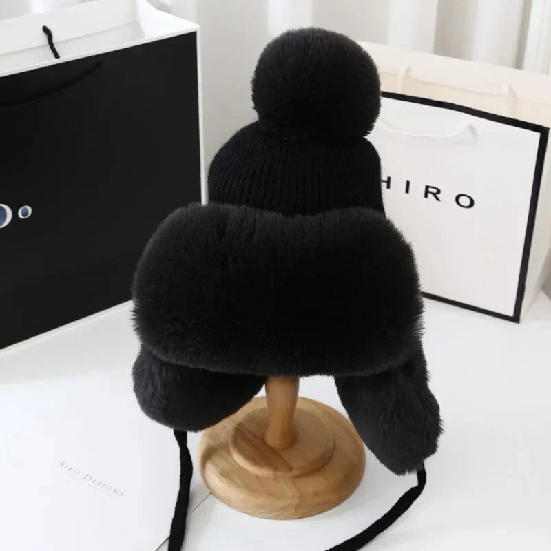 Schwarze Wintermütze mit Fellbesatz, Bommel, Ohrenschützer, warm, modisch, Unisex.