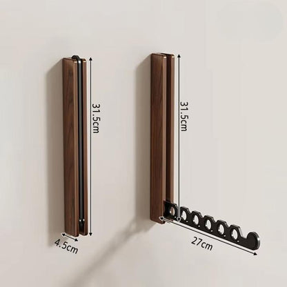 Maßdarstellung des Wandhakens aus dunklem Holz, eingeklappt und ausgeklappt, mit eingezeichneten Höhen-, Breiten- und Armlängenangaben. 10