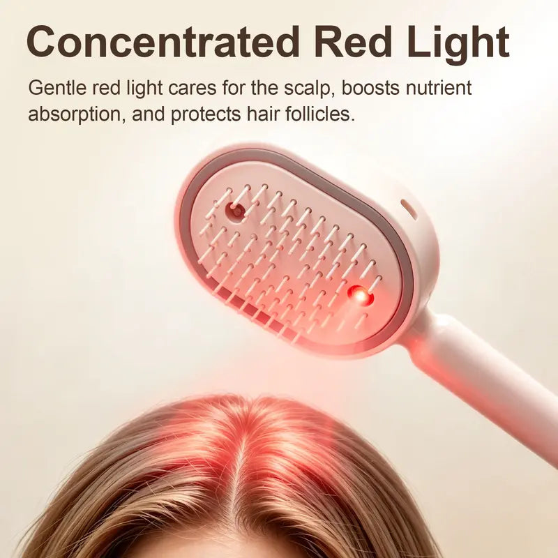 Sprüh-Luftkissen-Massagekamm mit roter Lichtquelle zwischen den Zinken auf einem hellbraunen Scheitel, Detail