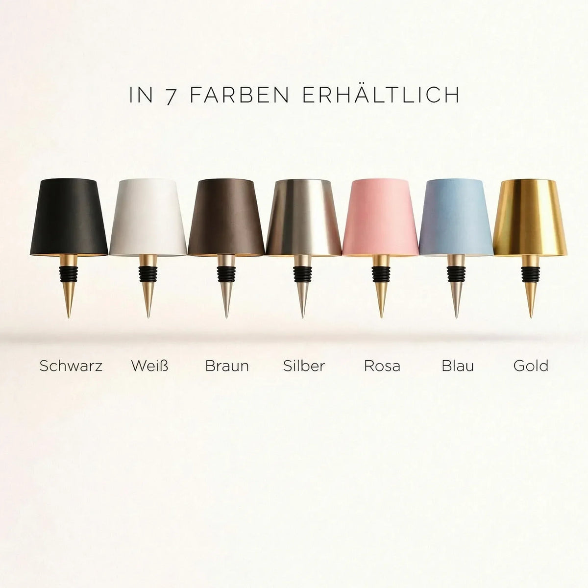 Sieben Lampenschirme mit Flaschenstopfen in Schwarz, Weiß, Braun, Silber, Rosa, Blau und Gold nebeneinander 3