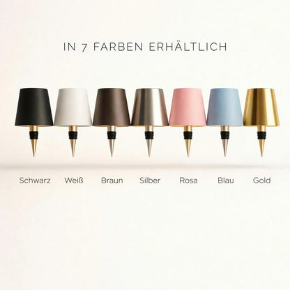 Sieben Lampenschirme mit Flaschenstopfen in Schwarz, Weiß, Braun, Silber, Rosa, Blau und Gold nebeneinander 3