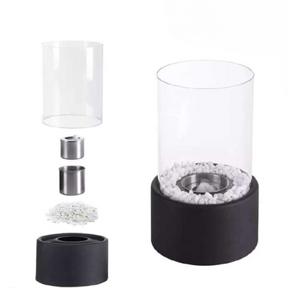 Glas-Öllampe mit schwarzem Sockel, weißen Steinen, Edelstahlbrenner, dekorative Beleuchtung.