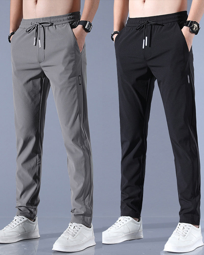 Graue und schwarze Herren-Sporthosen, elastischer Bund, Kordelzug, seitliche Taschen.