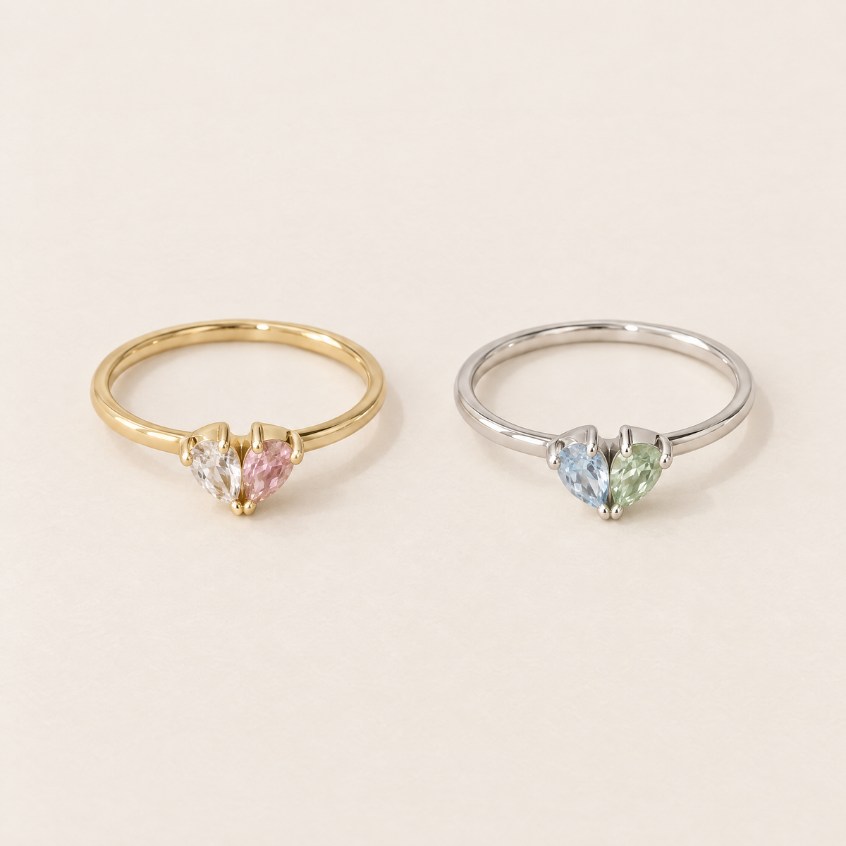 Zwei Ringe nebeneinander: links in Gold mit klarem und rosa Stein, rechts in Silber mit hellblauem und grünem Stein. 4
