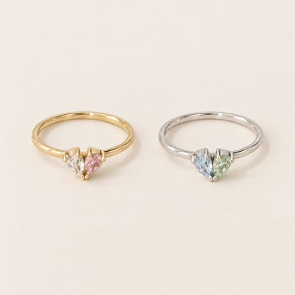 Zwei Ringe nebeneinander: links in Gold mit klarem und rosa Stein, rechts in Silber mit hellblauem und grünem Stein. 4