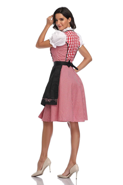 Rot-weiß kariertes Dirndl mit schwarzer bestickter Schürze und weißen Puffärmeln, Rückansicht.