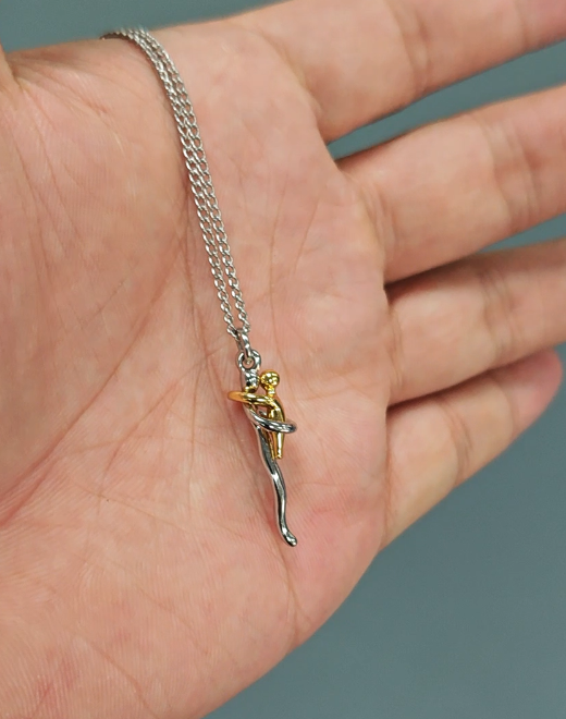 Anhänger-Halskette mit silber-goldenem Umarmungs-Anhänger auf einer offenen Handfläche
