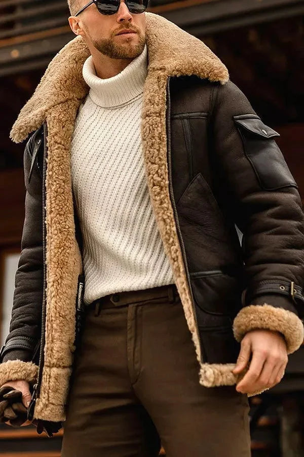 Mann in brauner Lederjacke mit Lammfellkragen, weißem Rollkragenpullover, Sonnenbrille.